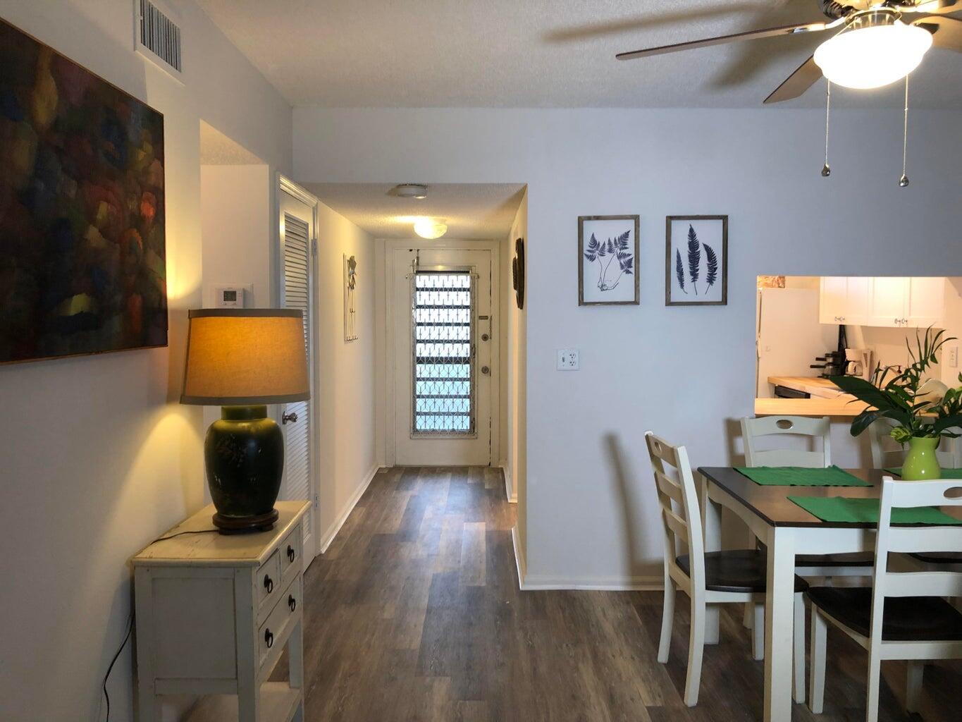 9826 Marina Boulevard, Unit 1023 Boca Raton, FL 33428 - Photo 4 of 31 a view of a dining room with furniture and wooden floor