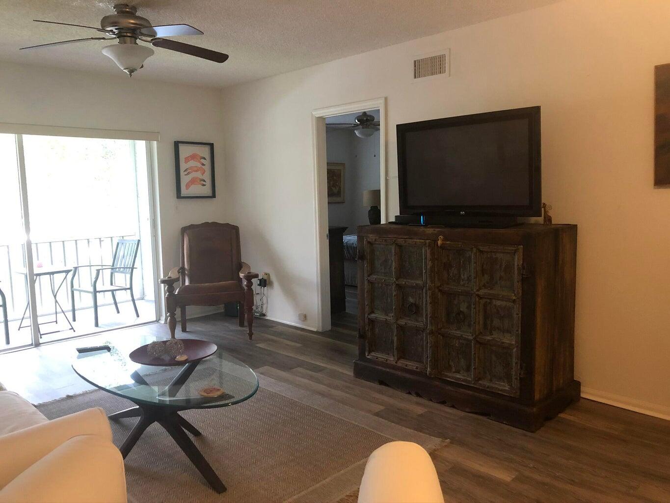 9826 Marina Boulevard, Unit 1023 Boca Raton, FL 33428 - Photo 5 of 31 a living room with furniture and a flat screen tv