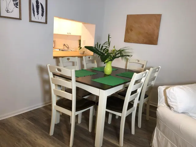 a dining room with furniture and window