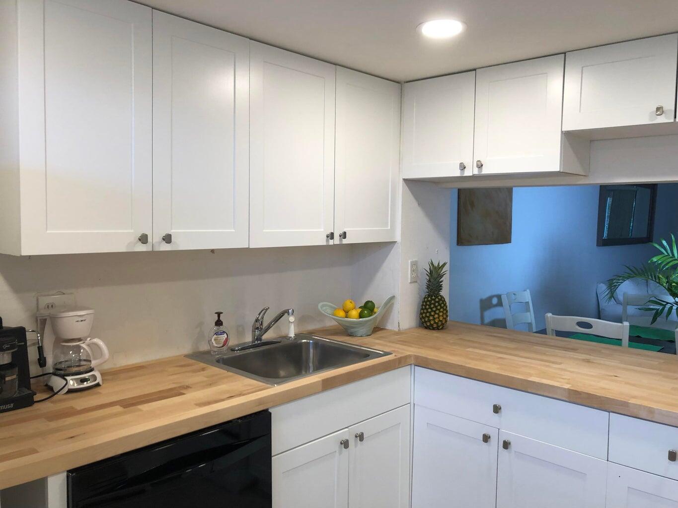 9826 Marina Boulevard, Unit 1023 Boca Raton, FL 33428 - Photo 9 of 31 a kitchen with a sink cabinets and window