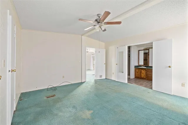 a view of a livingroom with a ceiling fan & a ceiling fan