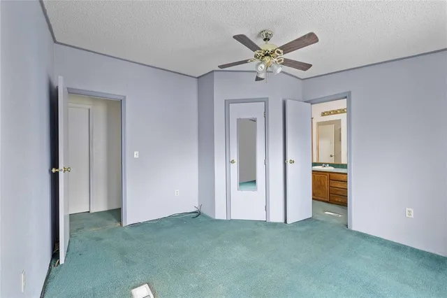 a view of an empty room with a ceiling fan