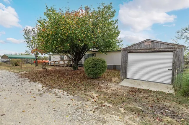 a view of a house with a yard and garage