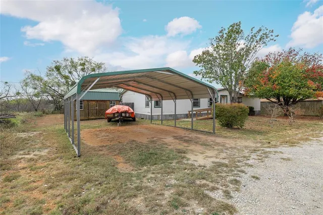 a backyard of a house with table and chairs