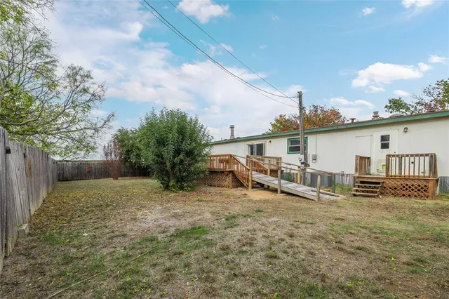 a view of a house with backyard and porch