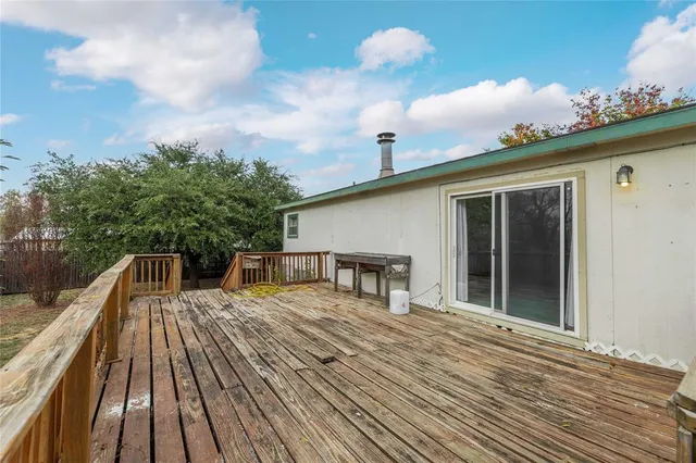a view of a house with pool and wooden floor