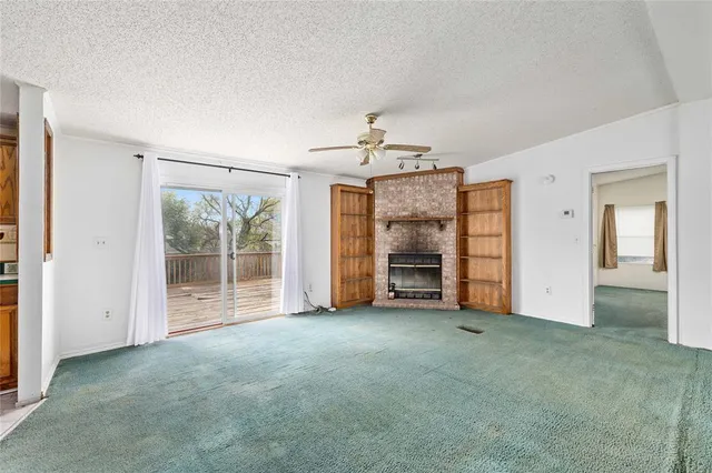 an empty room with fireplace and closet