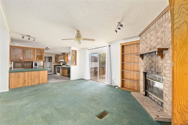 a view of kitchen with furniture and refrigerator