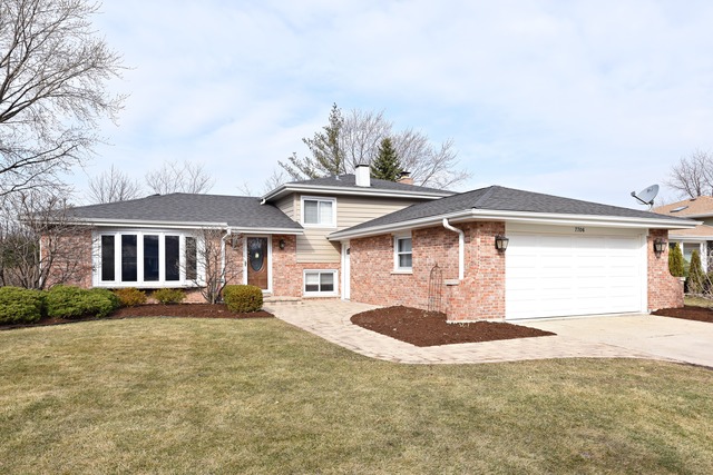 7706 Sawyer Road Darien, IL 60561 - Photo 1 of 10 a front view of a house with a yard and garage