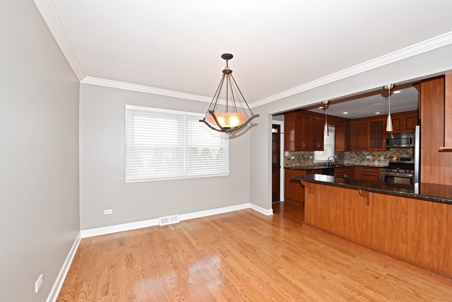 7706 Sawyer Road Darien, IL 60561 - Photo 3 of 10 a view of a kitchen with granite countertop cabinets and window