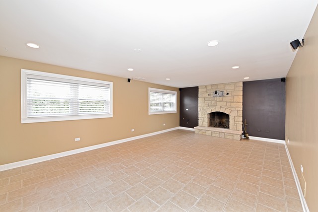 7706 Sawyer Road Darien, IL 60561 - Photo 5 of 10 a view of livingroom with furniture a fireplace and windows