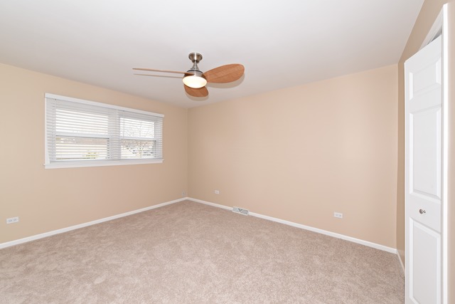 7706 Sawyer Road Darien, IL 60561 - Photo 7 of 10 an empty room with windows and fan