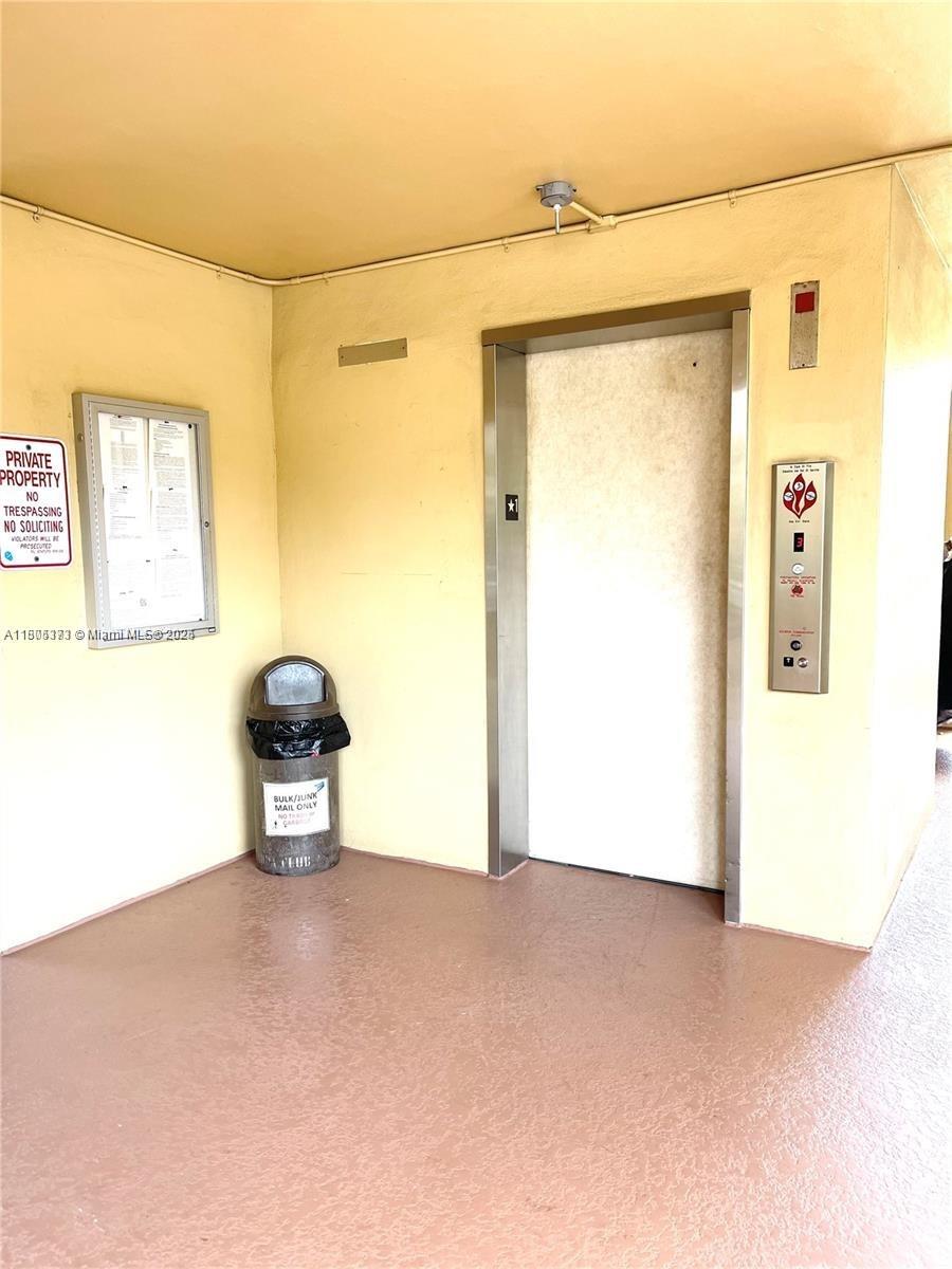 6071 Northwest 61st Avenue, Unit 311 Tamarac, FL 33319 - Photo 12 of 13 a view of a room with a refrigerator and wooden floor