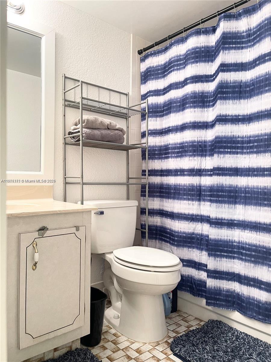 6071 Northwest 61st Avenue, Unit 311 Tamarac, FL 33319 - Photo 5 of 13 a bathroom with a sink toilet and shower