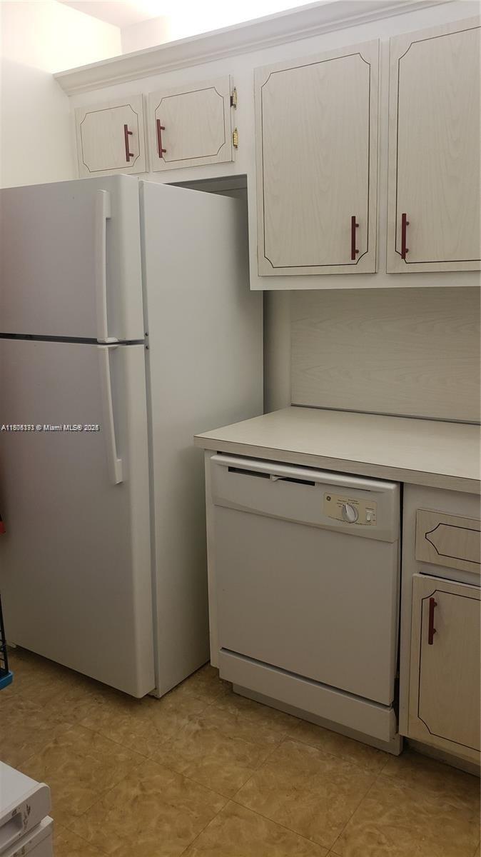 6071 Northwest 61st Avenue, Unit 311 Tamarac, FL 33319 - Photo 7 of 13 a utility room with dryer and washer