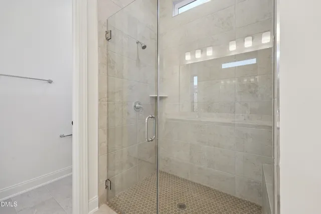 a bathroom with a glass shower door