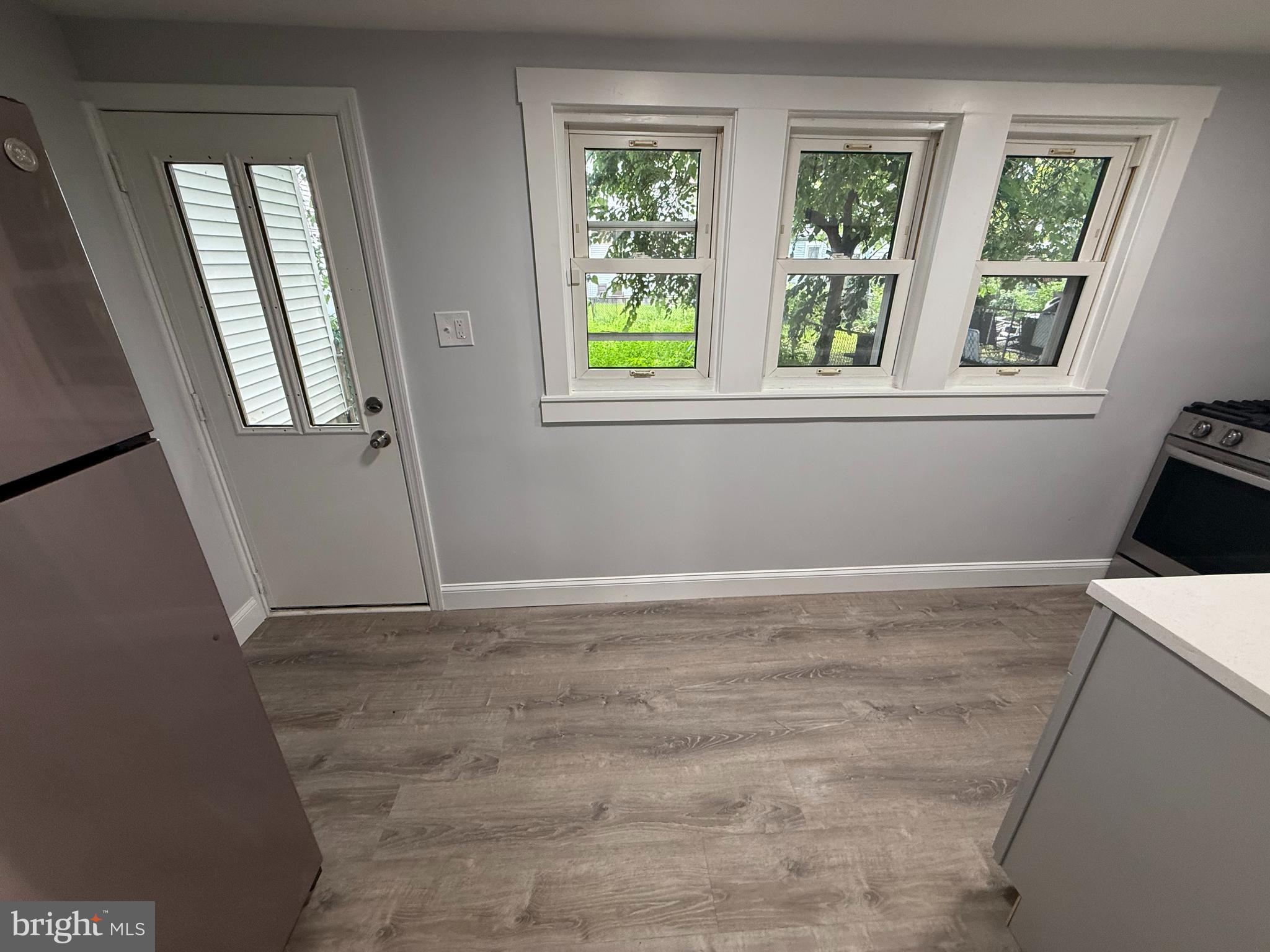 340 Middlesex Street Gloucester City, NJ 08030 - Photo 14 of 35 a view of an empty room with window and wooden floor