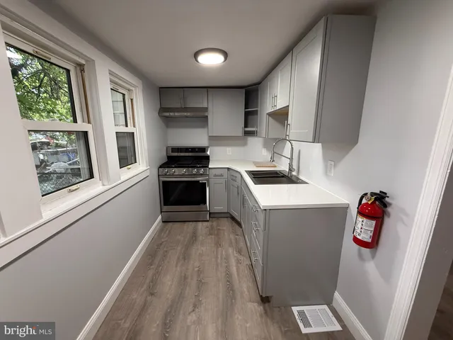 a kitchen with cabinets appliances and a sink