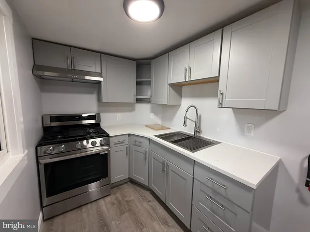 an empty room with wooden floor and window