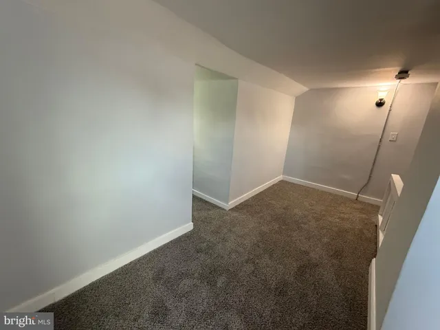 a view of a livingroom with an empty space and a window