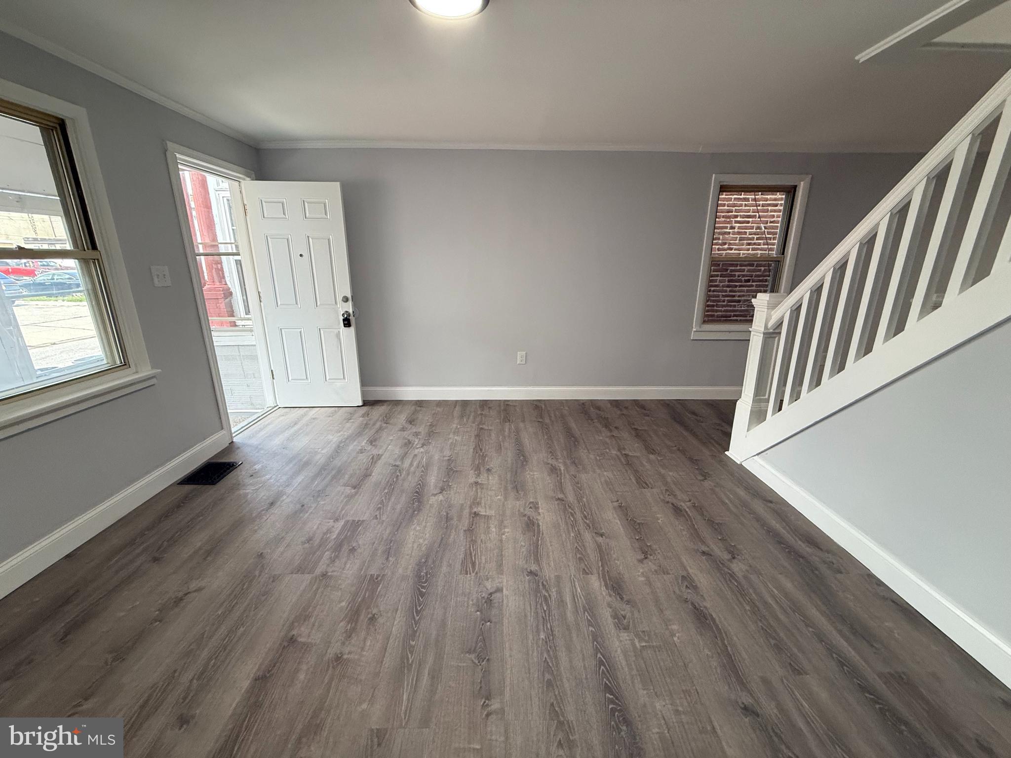 340 Middlesex Street Gloucester City, NJ 08030 - Photo 7 of 35 a view of an empty room with wooden floor and stairs