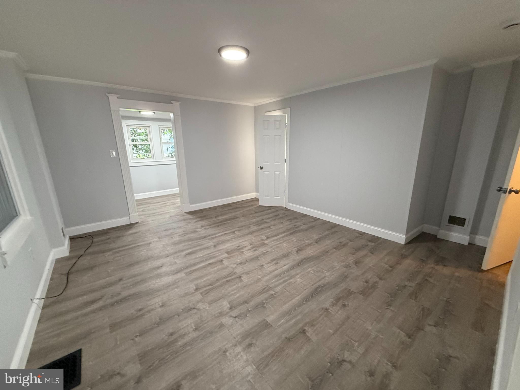 340 Middlesex Street Gloucester City, NJ 08030 - Photo 10 of 35 wooden floor in an empty room with a window
