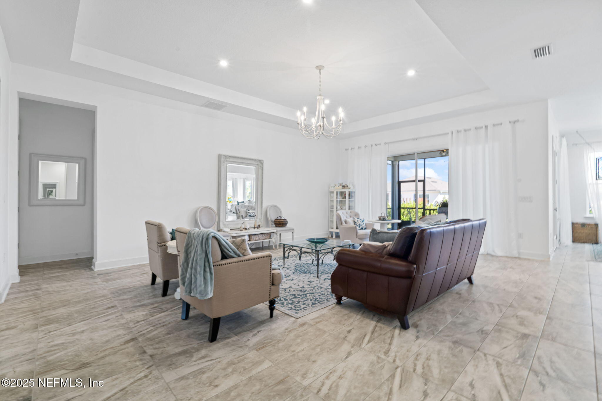 63 Braddock Court St. Augustine, FL 32092 - Photo 11 of 64 a living room with furniture and a chandelier