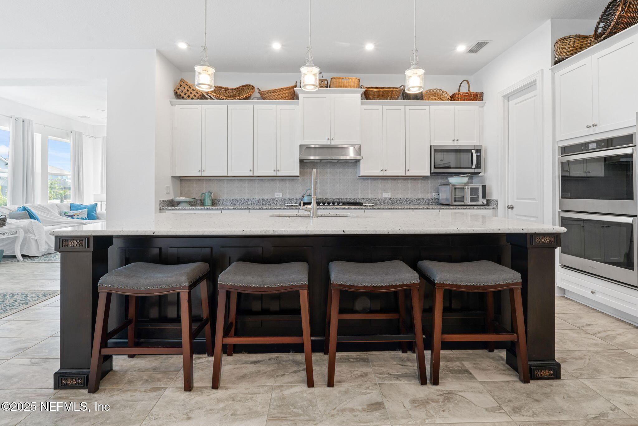 63 Braddock Court St. Augustine, FL 32092 - Photo 16 of 64 a kitchen with kitchen island granite countertop a table and chairs in it