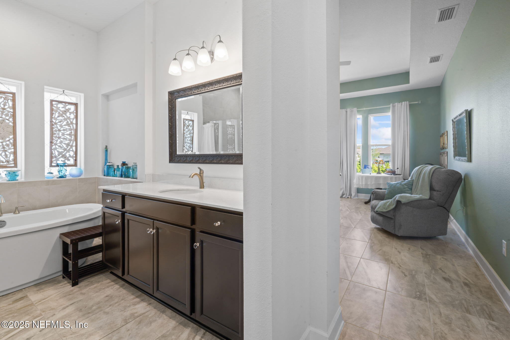 63 Braddock Court St. Augustine, FL 32092 - Photo 26 of 64 a en suite bathroom with a granite countertop sink and a large mirror