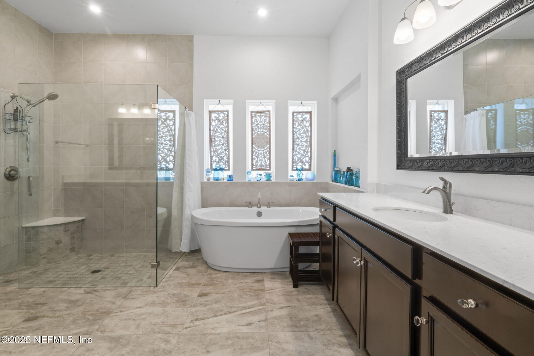 63 Braddock Court St. Augustine, FL 32092 - Photo 27 of 64 a bathroom with a granite countertop sink a toilet and shower