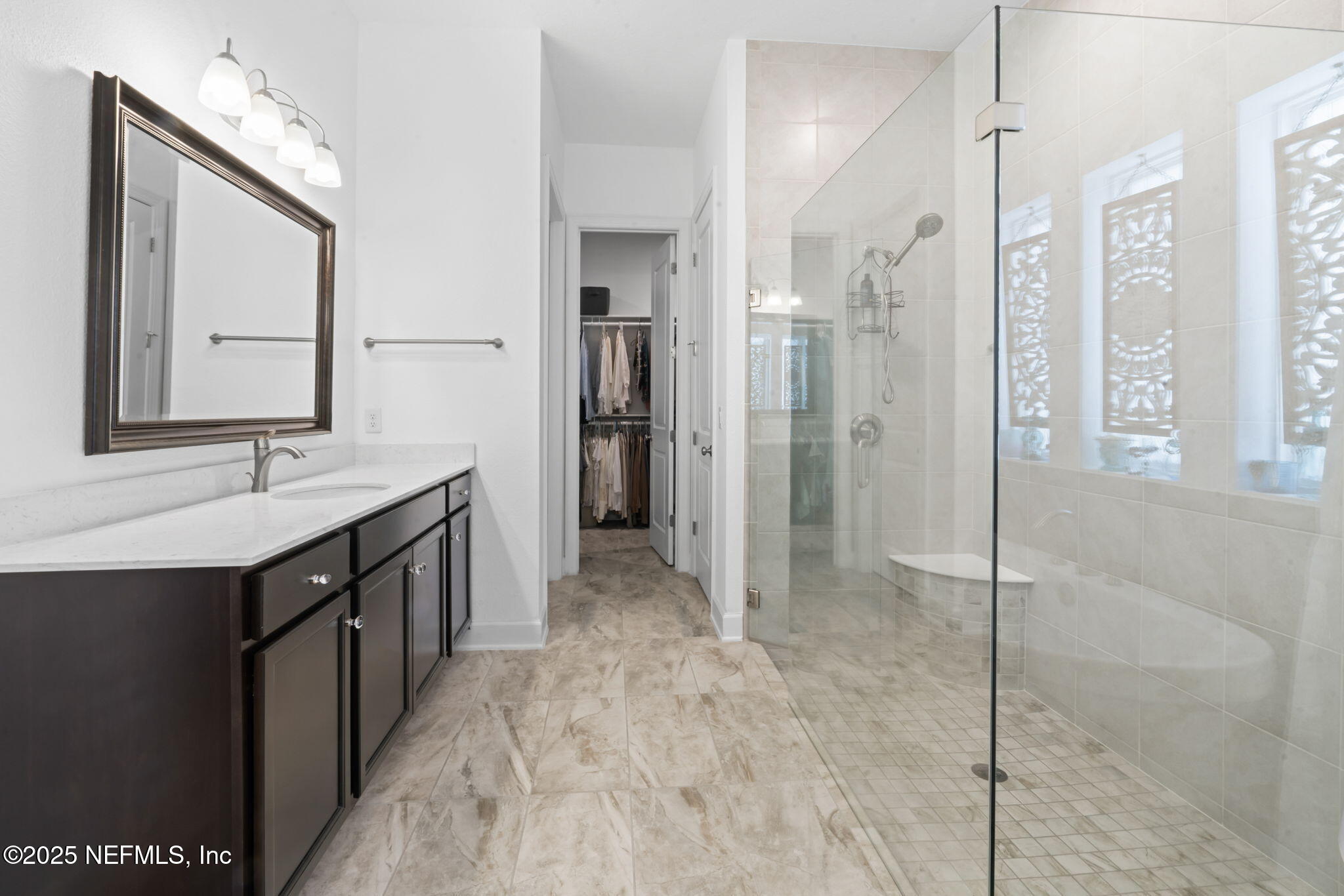 63 Braddock Court St. Augustine, FL 32092 - Photo 28 of 64 a spacious bathroom with a shower sink and mirror