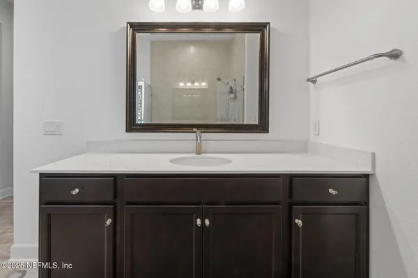 a bed room with a bed and a chair