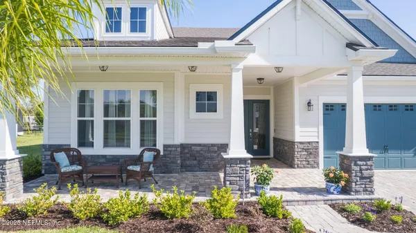 a front view of a house with outdoor seating and plants
