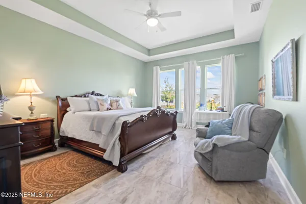 a bedroom with a bed and a chandelier