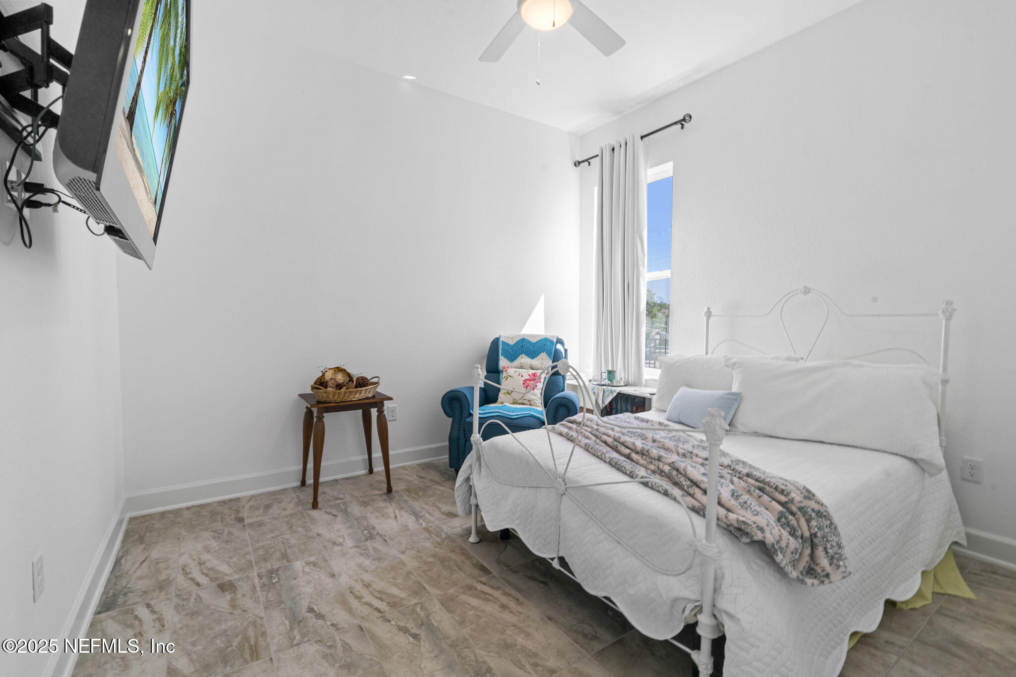 63 Braddock Court St. Augustine, FL 32092 - Photo 43 of 64 a bedroom with a bed and a chandelier