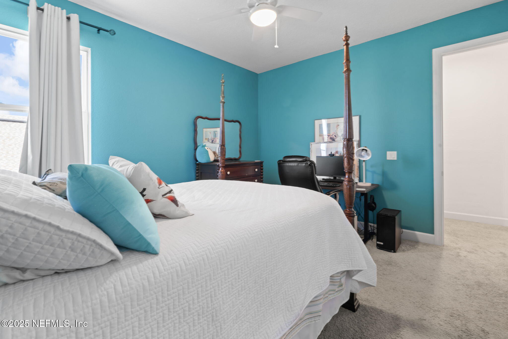 63 Braddock Court St. Augustine, FL 32092 - Photo 50 of 64 a bedroom with a bed and a chandelier