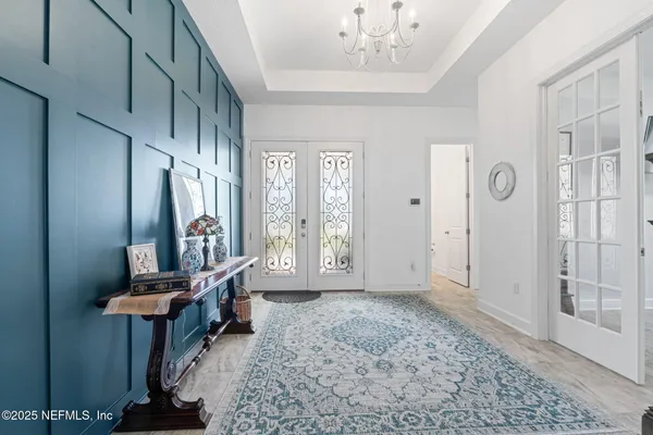 a living room with furniture and a chandelier
