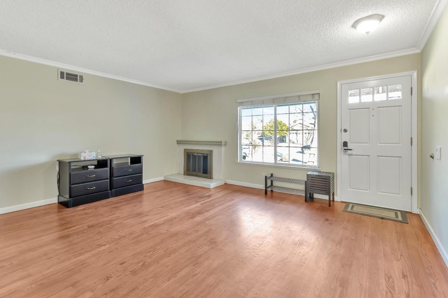 360 Henderson Drive San Jose, CA 95123 - Photo 17 of 37 an empty room with windows a fireplace and wooden floor
