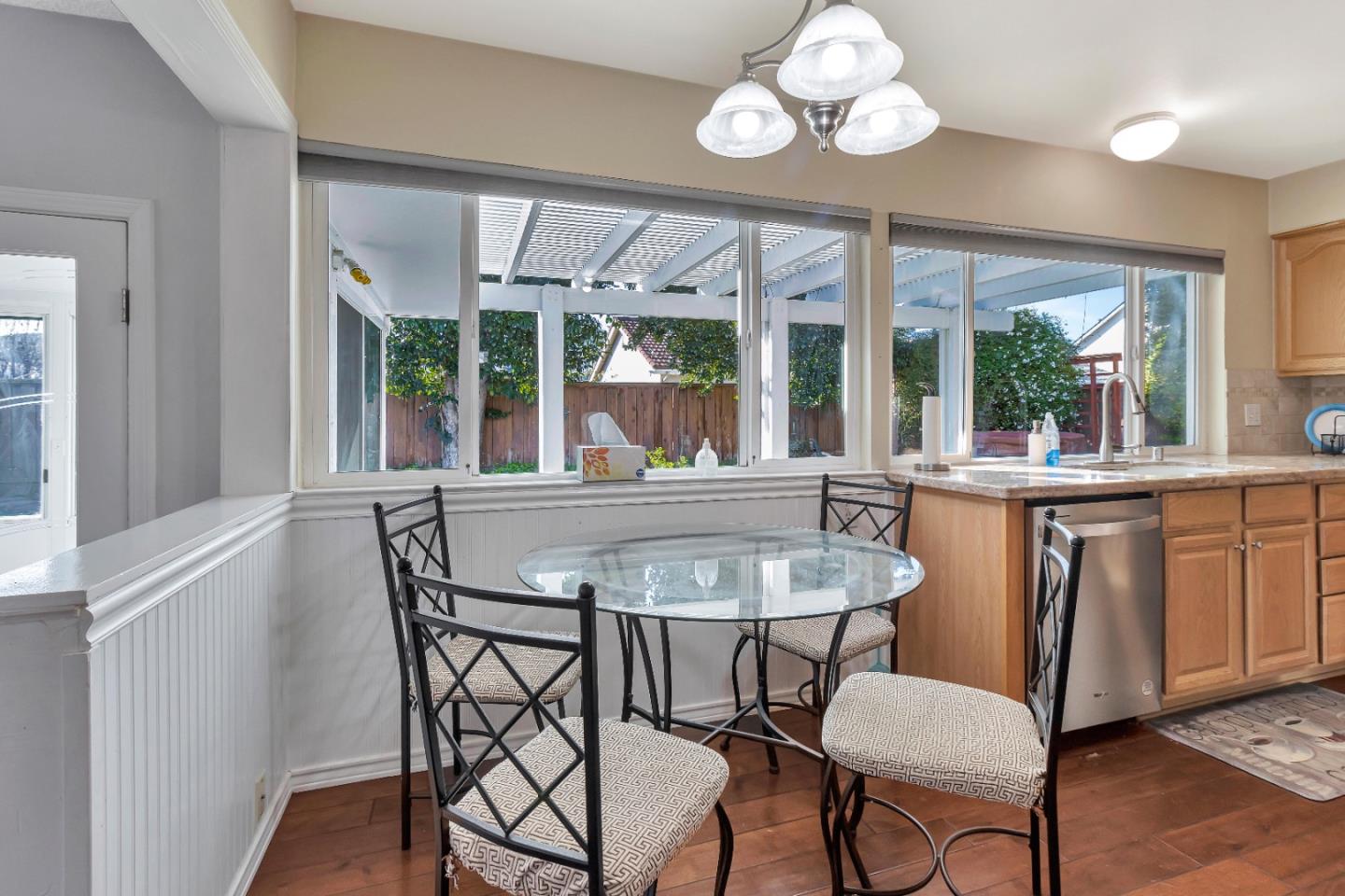 360 Henderson Drive San Jose, CA 95123 - Photo 8 of 37 a dining room with wooden floor a chandelier a wooden table and chairs