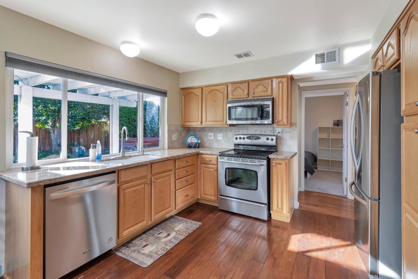 360 Henderson Drive San Jose, CA 95123 - Photo 10 of 37 a kitchen with granite countertop a stove a sink and a microwave
