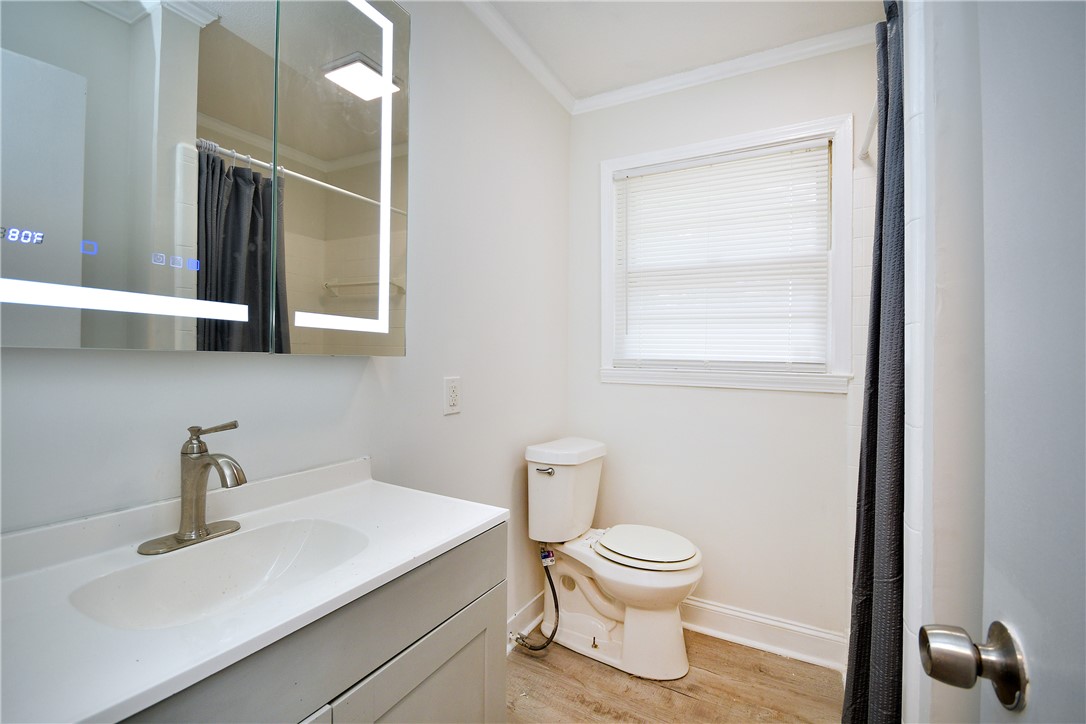 115 Stancil Road Anderson, SC 29625 - Photo 20 of 35 A well-lit primary bathroom features a sleek vanity and a contemporary illuminated mirror.