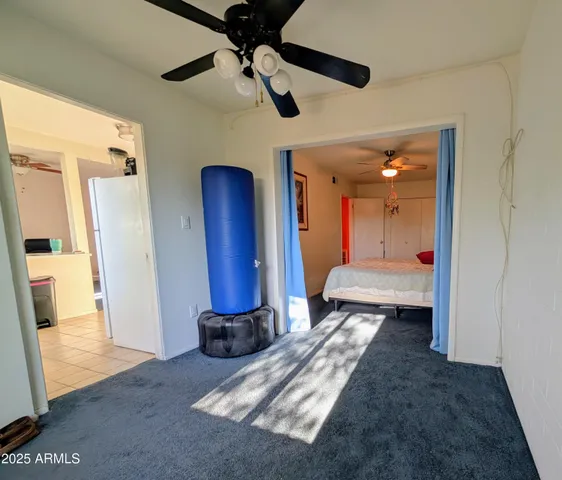 a bedroom with a bed and a mirror on the dresser