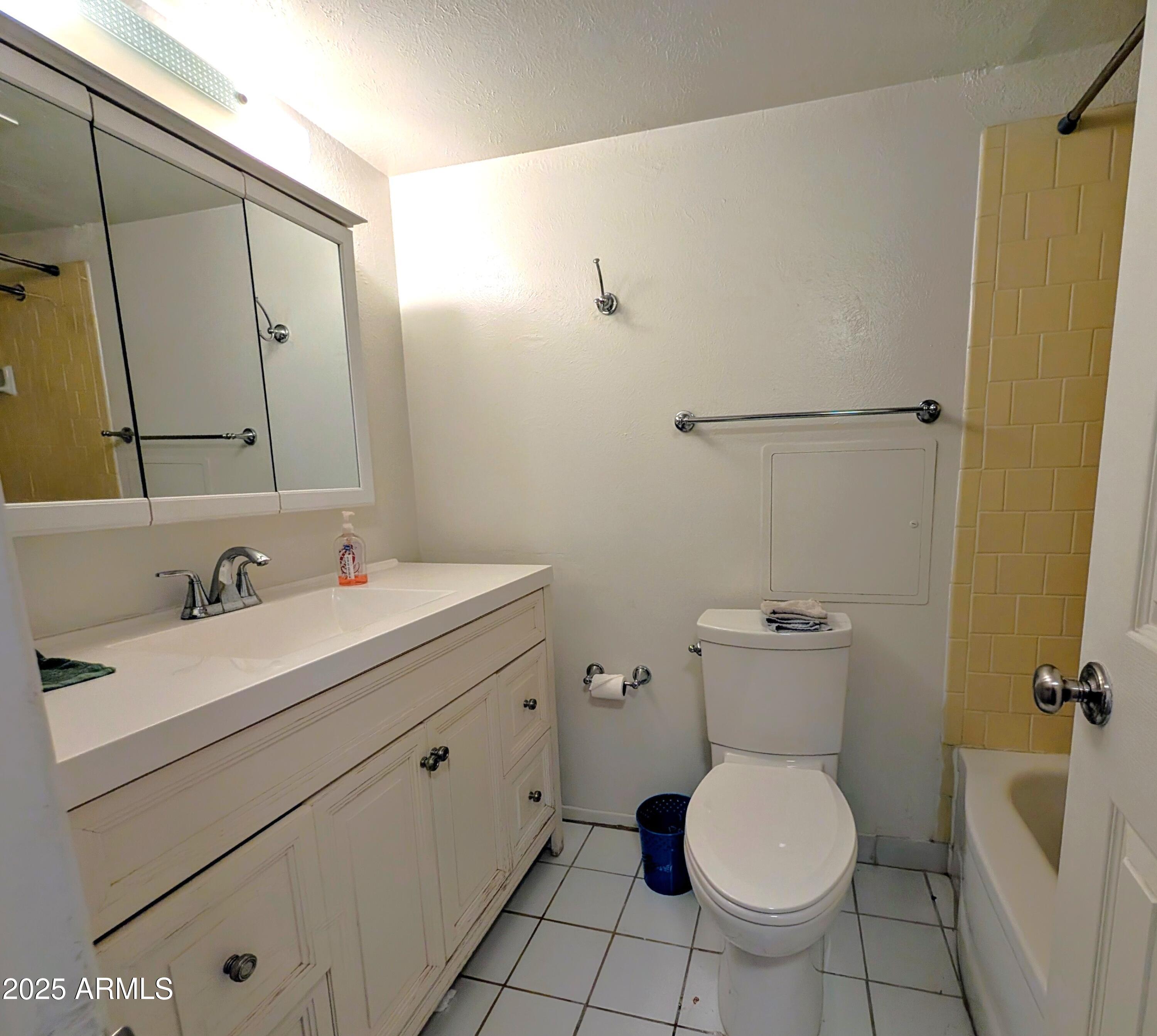 2610 West Berridge Lane, Unit 121 Phoenix, AZ 85017 - Photo 12 of 18 a bathroom with a sink toilet and a mirror