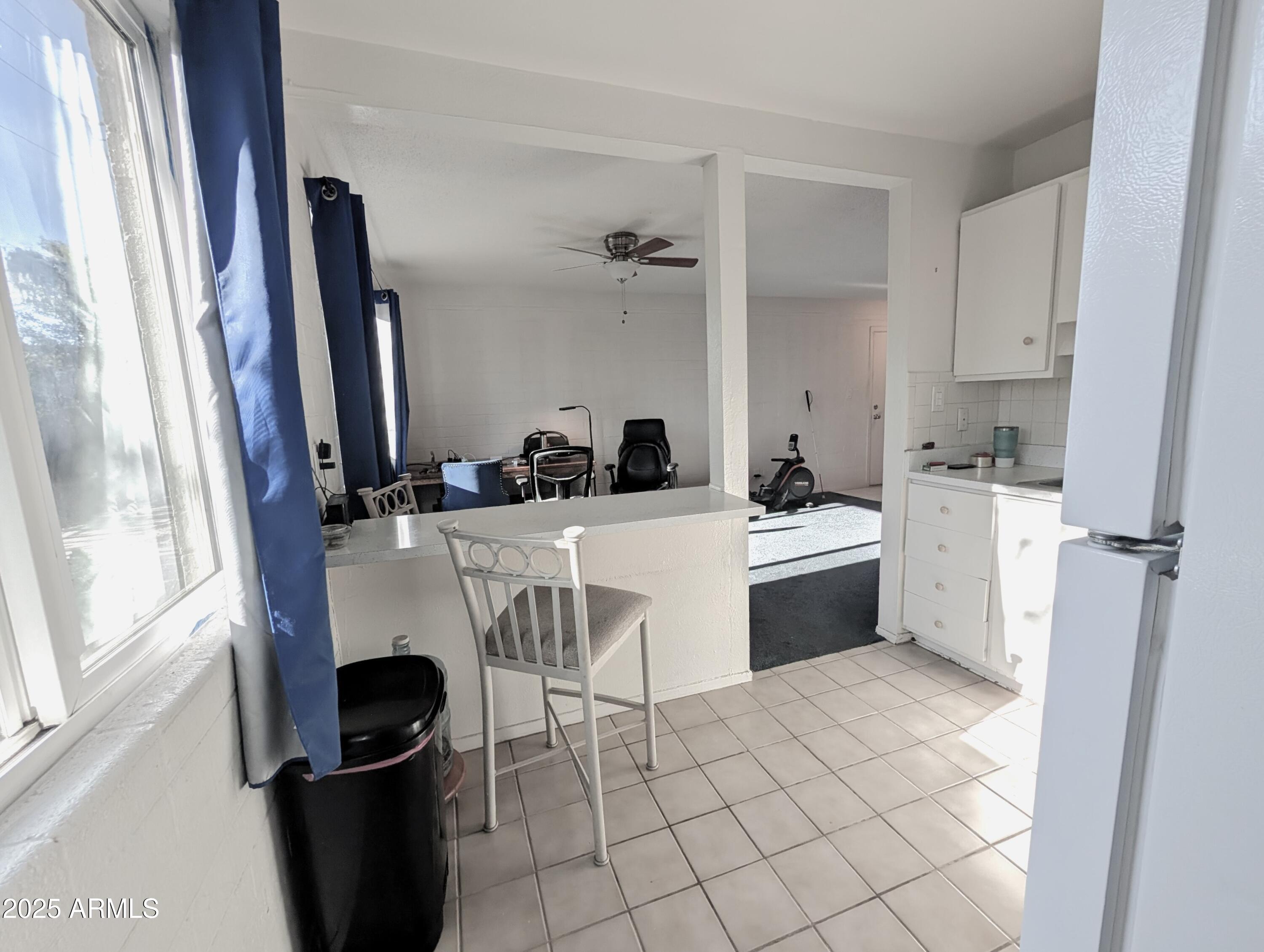 2610 West Berridge Lane, Unit 121 Phoenix, AZ 85017 - Photo 15 of 18 a kitchen with a sink cabinets and window