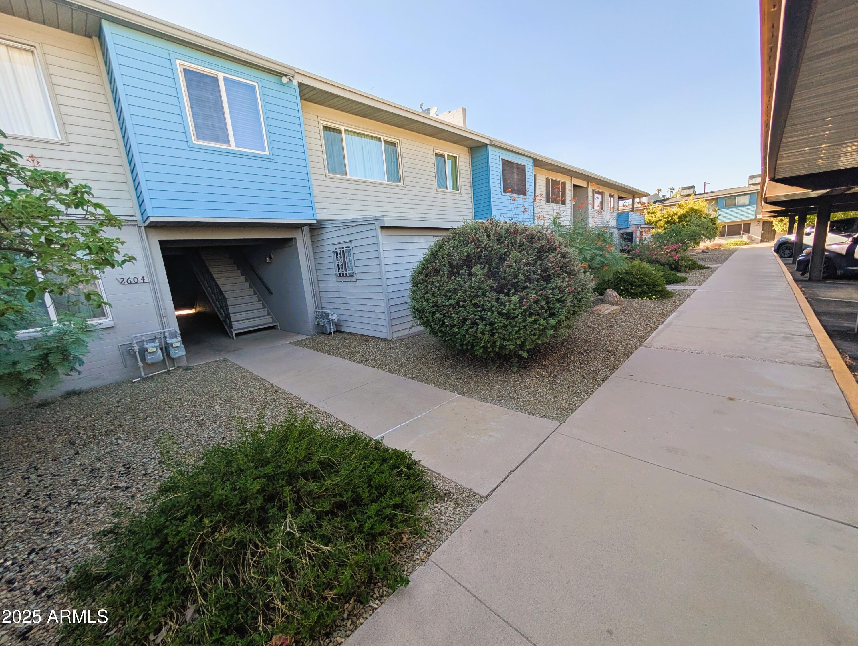 2610 West Berridge Lane, Unit 121 Phoenix, AZ 85017 - Photo 2 of 18 a front view of a house with garden