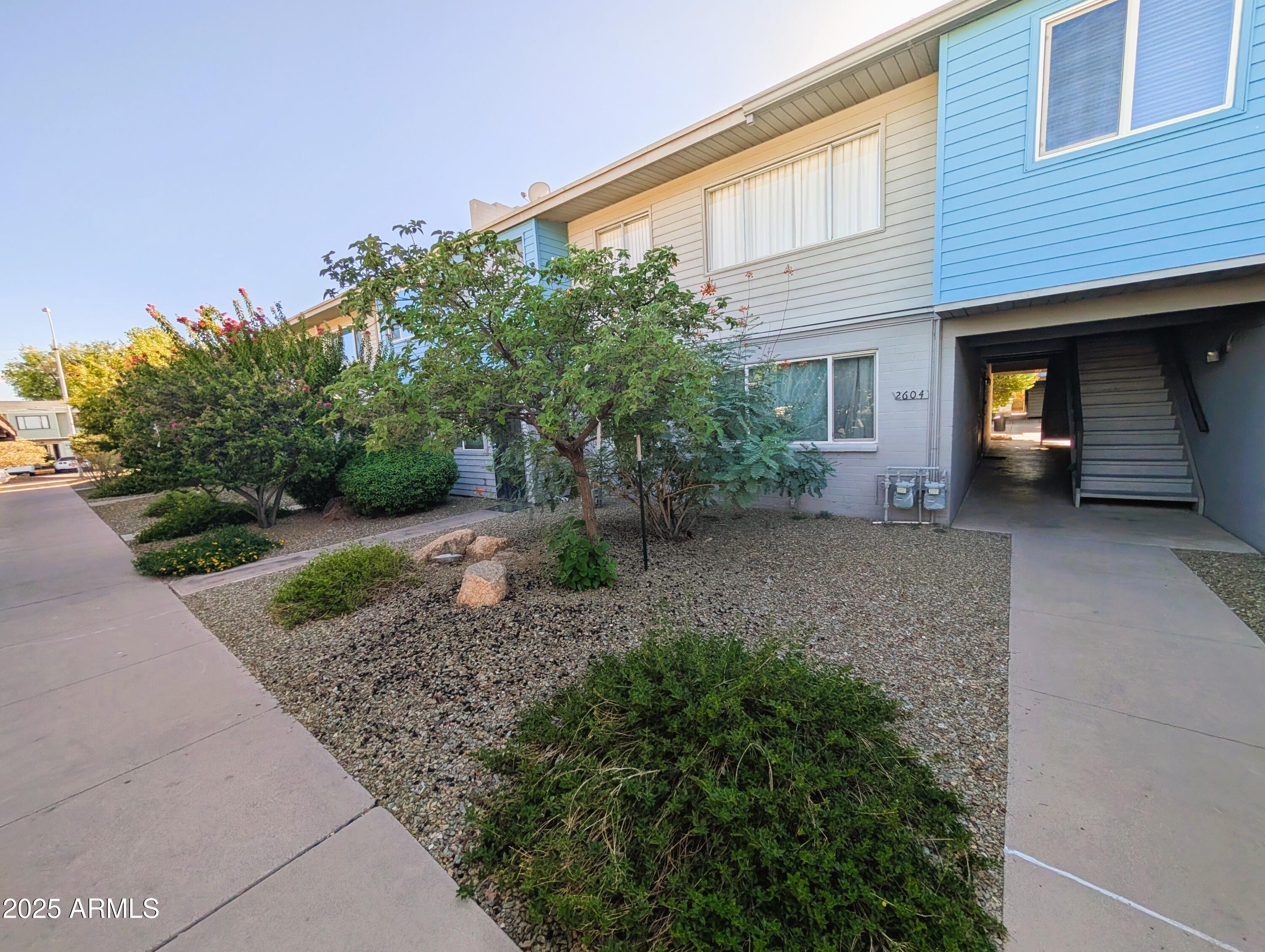 2610 West Berridge Lane, Unit 121 Phoenix, AZ 85017 - Photo 3 of 18 a view of a house with a yard and potted plants
