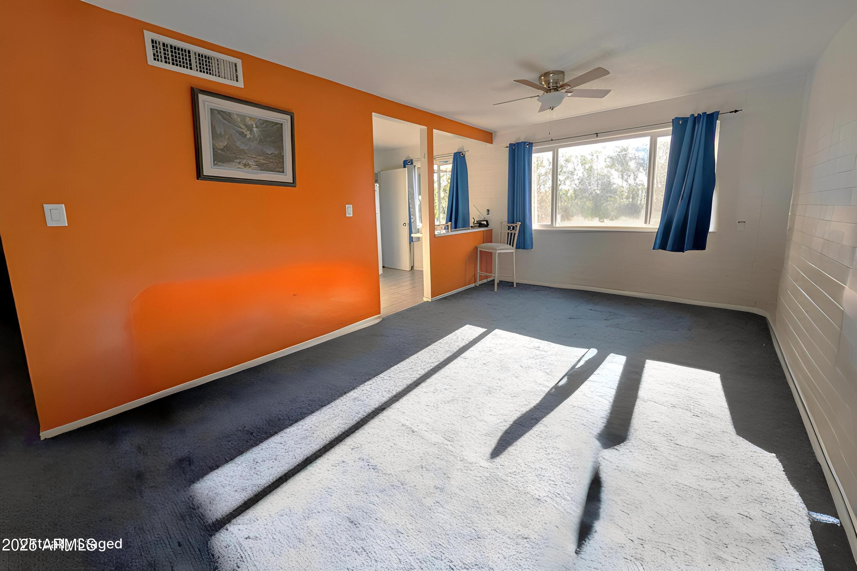 2610 West Berridge Lane, Unit 121 Phoenix, AZ 85017 - Photo 5 of 18 a view of an empty room with a window
