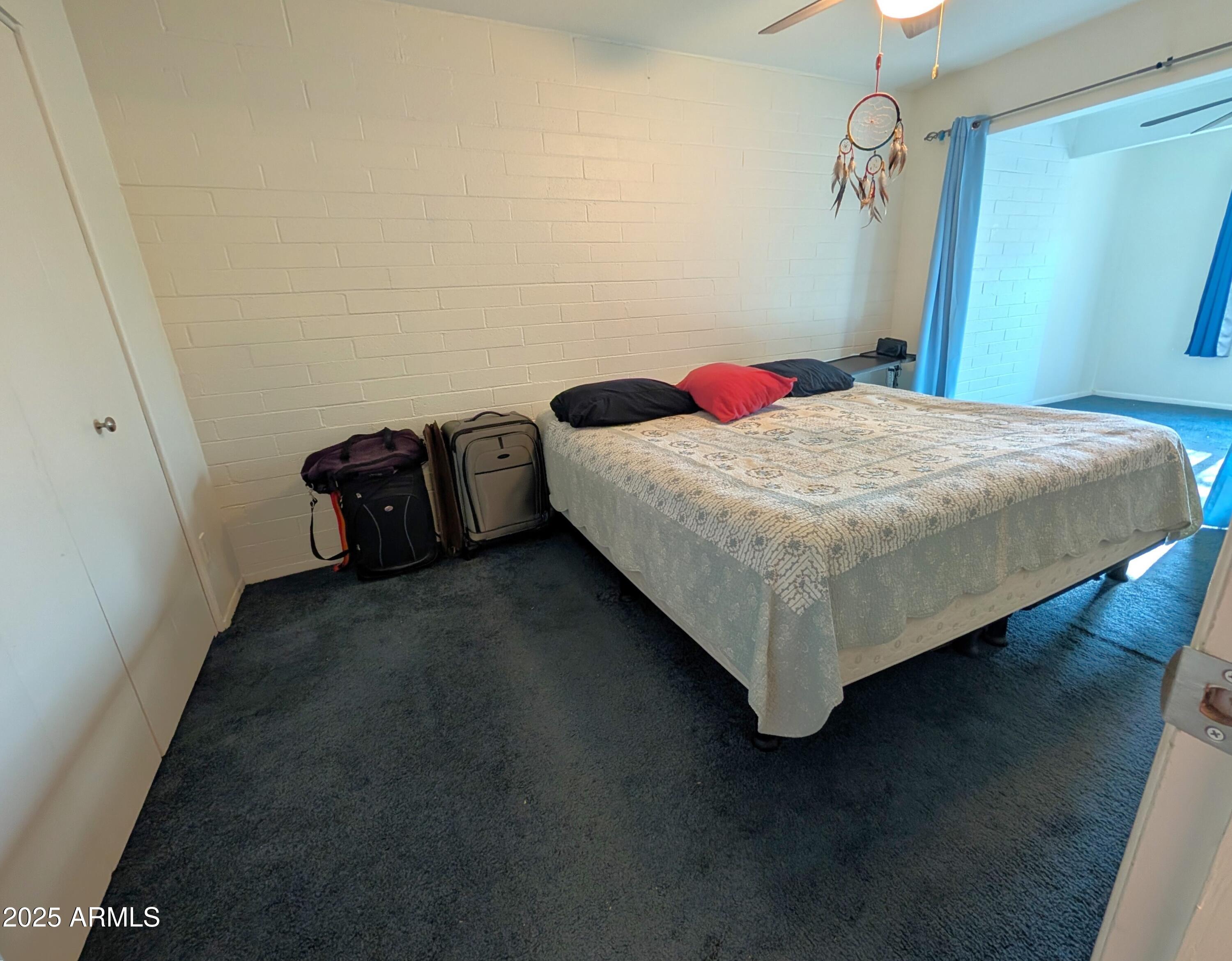 2610 West Berridge Lane, Unit 121 Phoenix, AZ 85017 - Photo 6 of 18 a bed sitting in a bedroom next to a bathroom