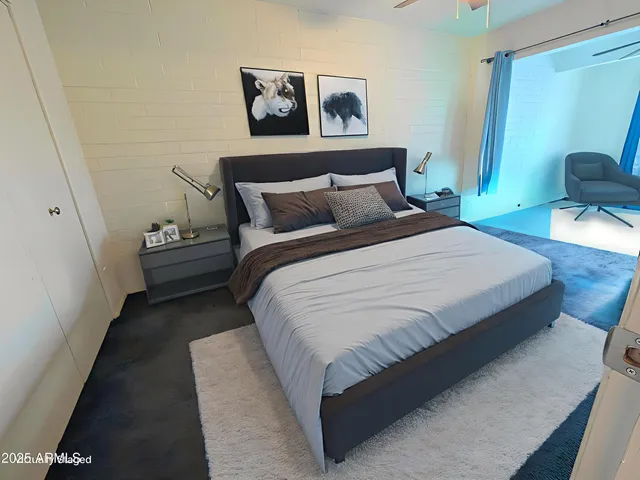 a bedroom with bed and cupboard