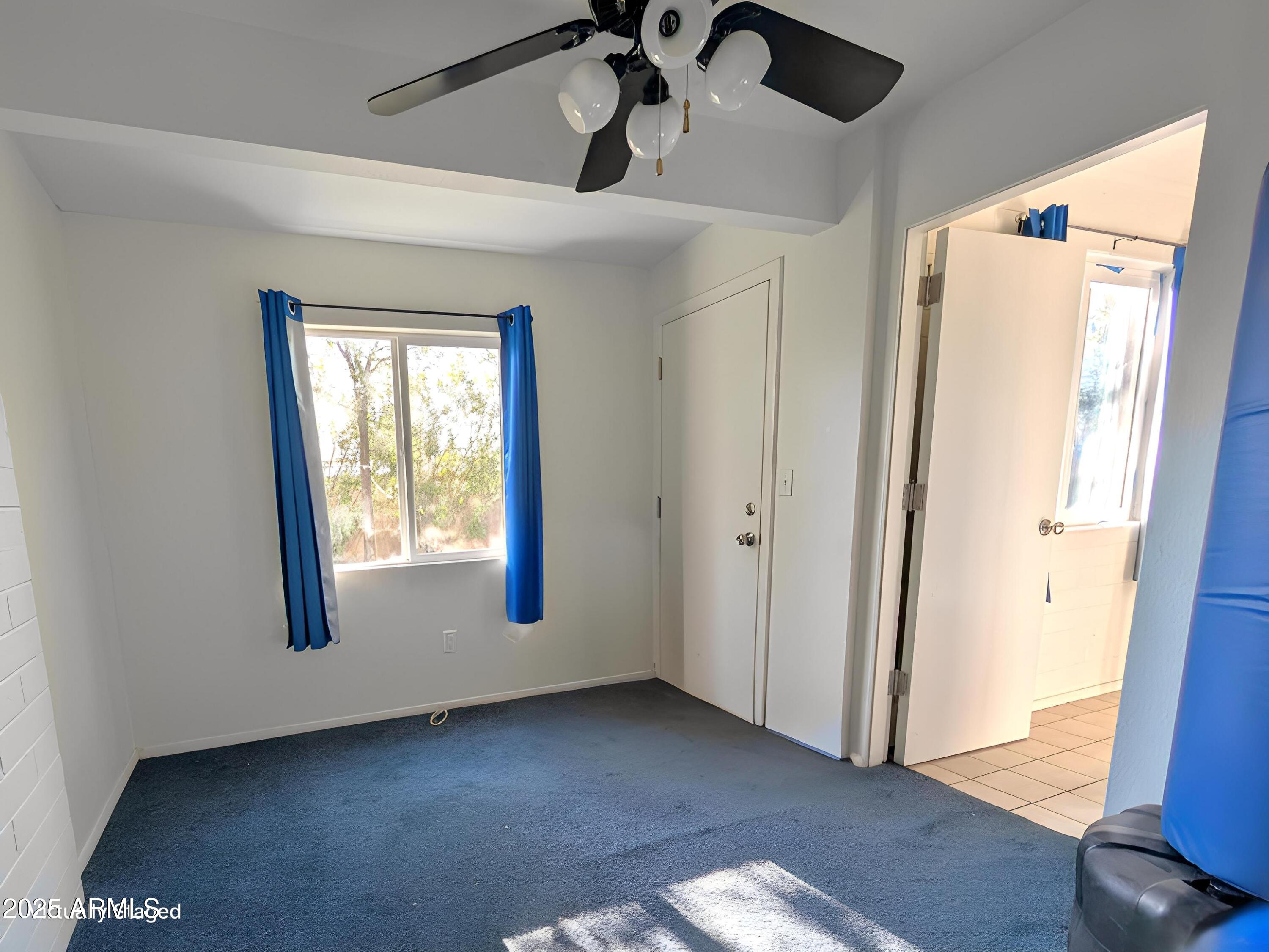 2610 West Berridge Lane, Unit 121 Phoenix, AZ 85017 - Photo 9 of 18 a view of an empty room and wooden floor